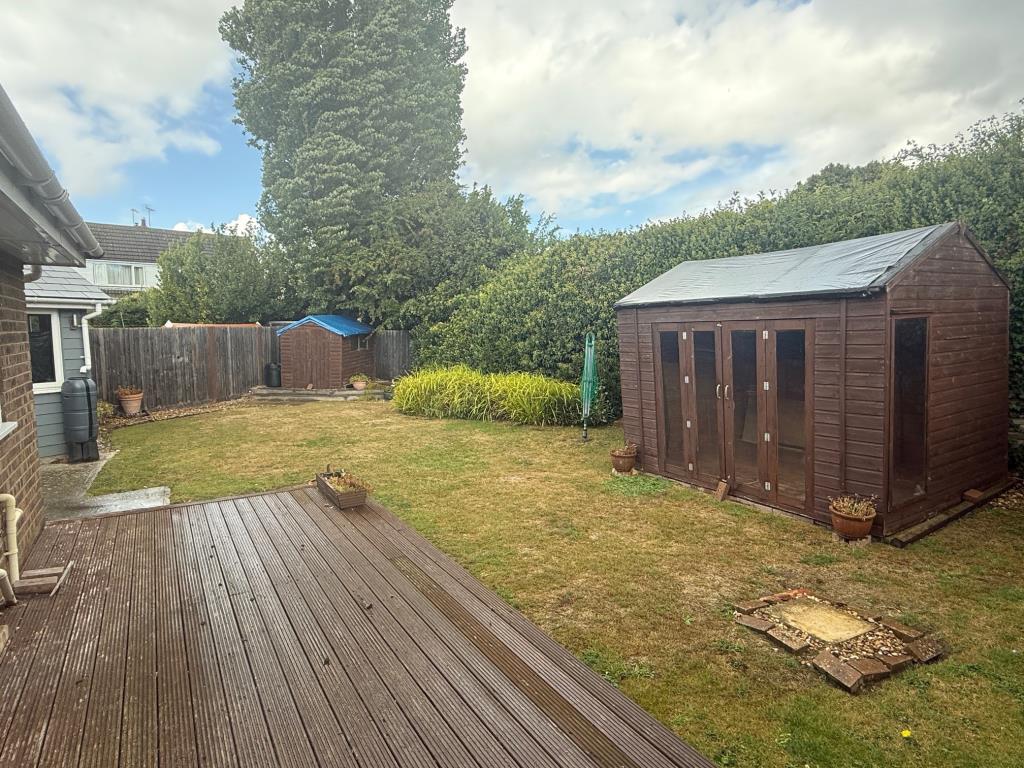 Lot: 134 - SEMI-DETACHED BUNGALOW FOR IMPROVEMENT - Rear garden with decking and two sheds